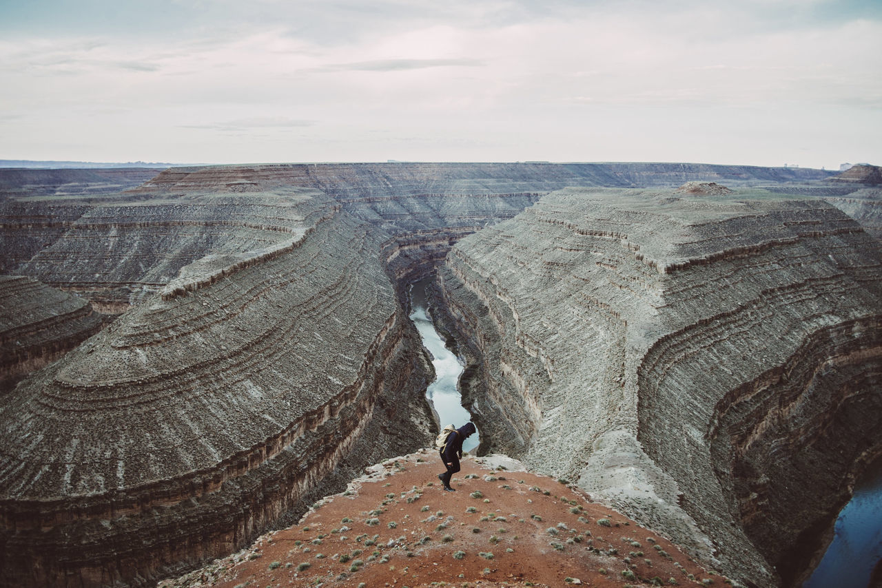 PANORAMIC VIEW OF PERSON ON ROCK AGAINST SKY