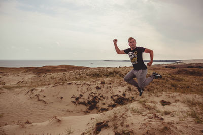 Man on beach against sky