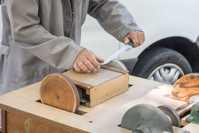 Midsection of man working in workshop