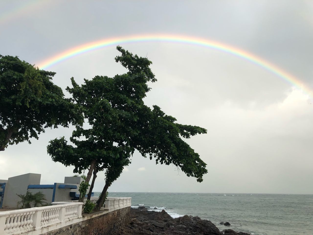 RAINBOW OVER SEA AGAINST SKY