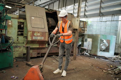 Side view of man working at construction site