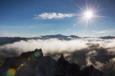 Aerial view rock of morning scenery golden light sunrise and the mist flows on high mountains, 
