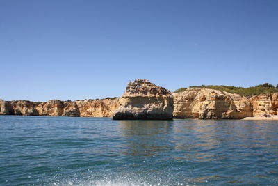 Scenic view of sea against clear blue sky