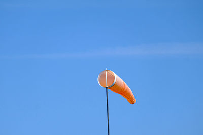 Low angle view of kite against clear blue sky