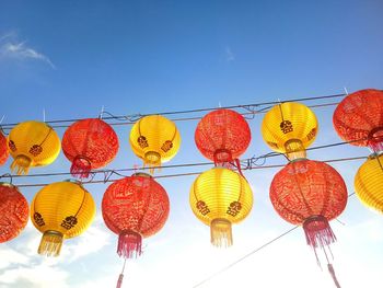 Low angle view of lanterns hanging against clear sky