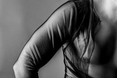 Close-up of woman standing against gray background