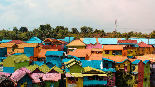 High angle view of colorful houses in city against sky