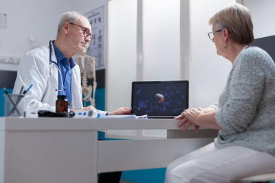 Side view of doctor working in office