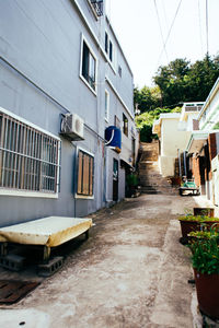 Street amidst houses against sky