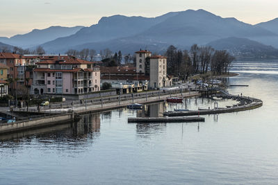 Scenic view of lake by buildings against sky