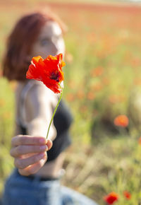 Young woman holding flower