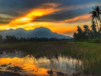 Scenic view of lake against sky during sunset