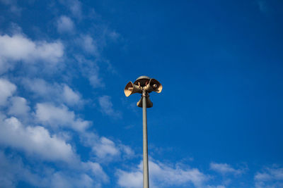 Low angle view of street light against blue sky