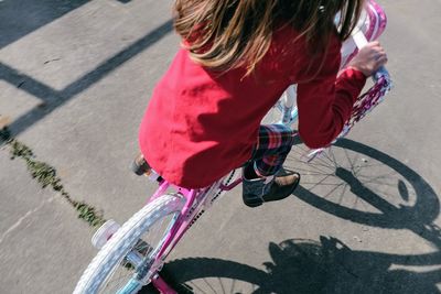 Girl riding bicycle on road