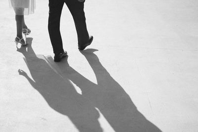 Low section of woman and man walking