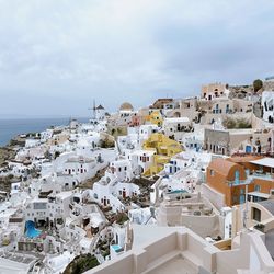 High angle view of townscape by sea against sky
