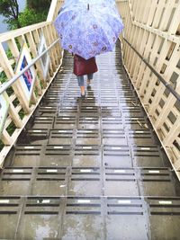 Full length of woman climbing steps