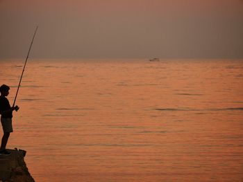 Silhouette of woman at sunset