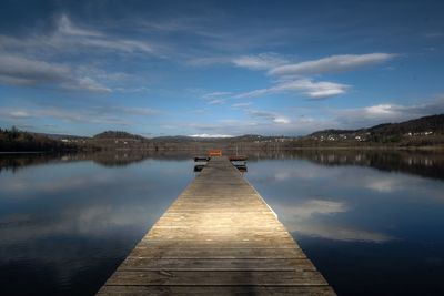 Pier over lake against sky