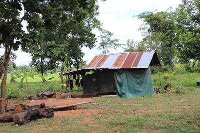 Abandoned house on field against sky