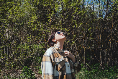 Portrait of a happy, free, peaceful woman in nature looking up. the concept of mental health,