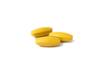 Close-up of yellow slices over white background