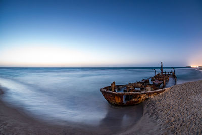 Scenic view of sea against clear sky during sunset