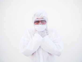 Portrait of person standing against white background