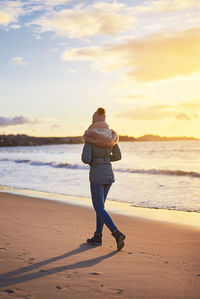 Rear view of man standing on beach