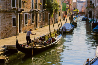 People traveling in gondola on canal