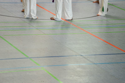 Low section of people practicing karate at training class