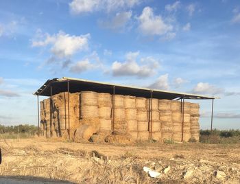 Built structure on field against sky