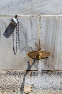 Close-up of chain hanging on wall