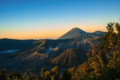 Scenic view of volcanic landscape against sky during sunset