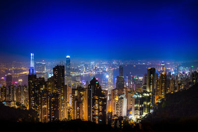 Illuminated cityscape against sky at night