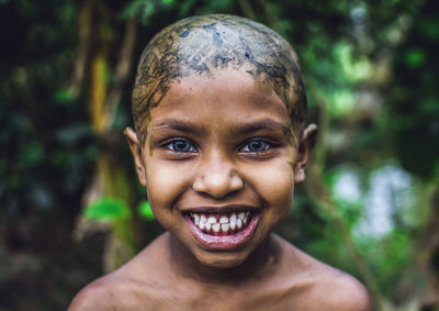 Close-up portrait of happy girl with herbs on scalp