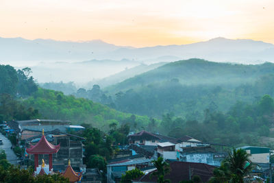 High angle view of houses and trees against sky