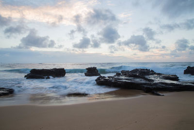 View of beach against cloudy sky