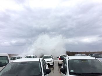 Panoramic view of cars on cloudy sky