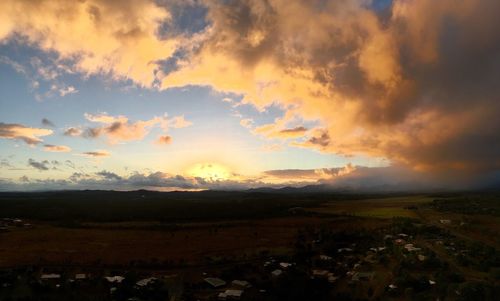 Scenic view of field against sky at sunset