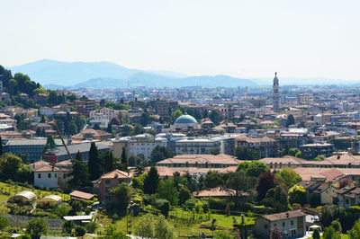 High angle view of houses in town against clear sky