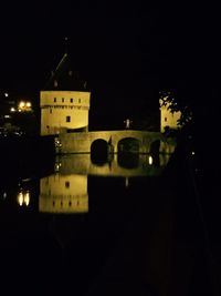 Illuminated city against sky at night