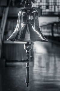 Close-up of an ancient temple bellhanging at a railway station. 