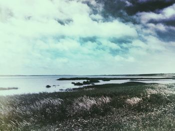 Scenic view of sea against cloudy sky