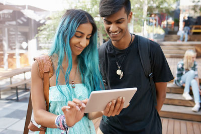 Friends looking at digital tablet