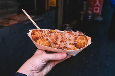 Close-up of hand holding meat