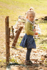 Rear view of boy standing on field