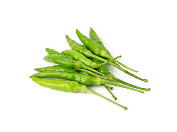 Close-up of green chili pepper against white background