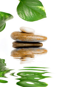 Stack of pebbles against white background