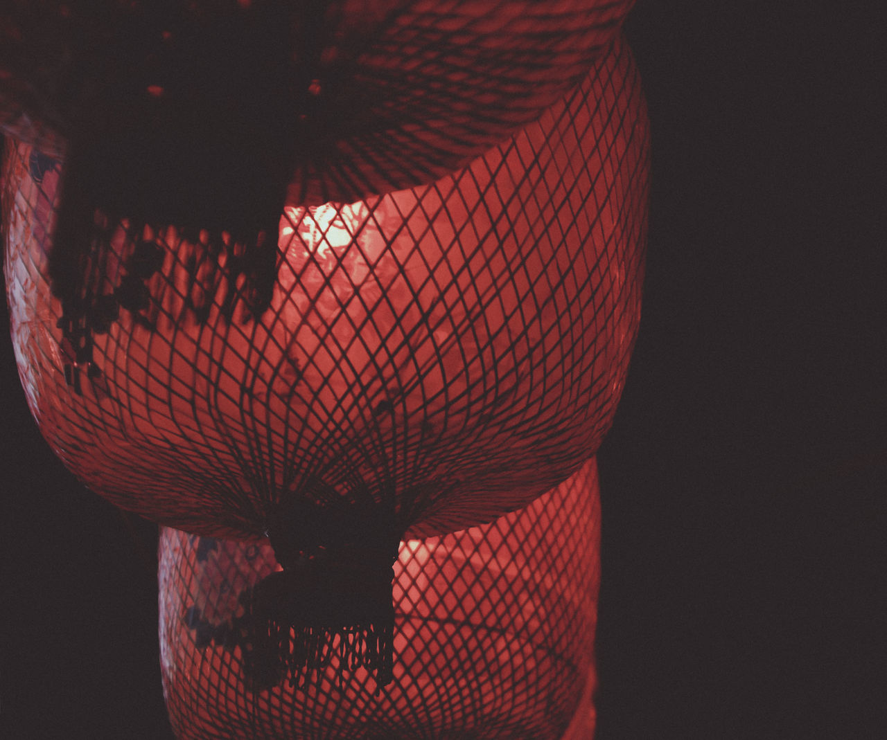 CLOSE-UP OF ILLUMINATED LANTERN AGAINST WALL